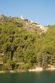 Hilltop castle of Guadalest above the calm waters of a lake