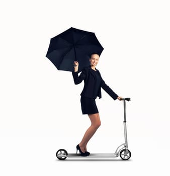 Image of young businesswoman in black riding scooter