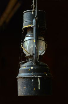 A Grungy Vintage Oil Lamp Hanging In A Barn