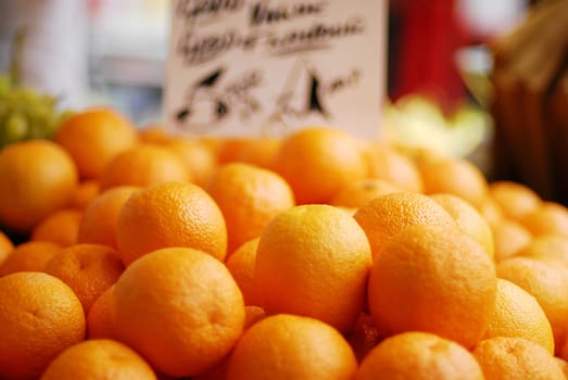 Closeup of fresh oranges offered at sale in a fruit market