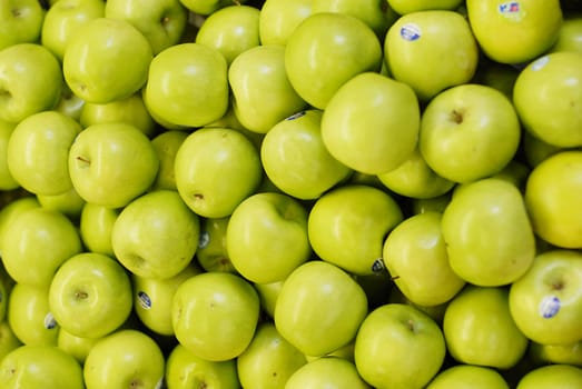 Closeup shot of green apples for sale at a marketplace