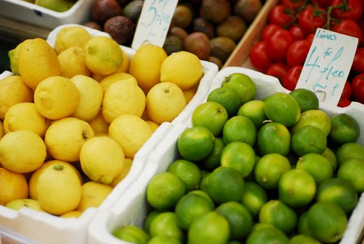 Fresh ripe limes and lemons in a marketplace.