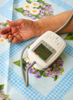 Hand of the person measuring pressure by medical instrument