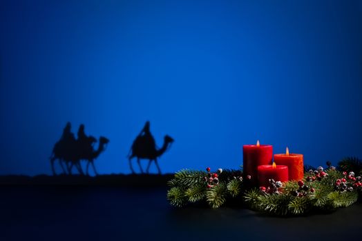 Three wise men on the way to Jesus in Bethlehem and candles