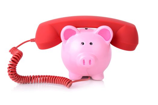 call the bank for support or telephone banking concept piggy bank with red phone reciver isoalted on white