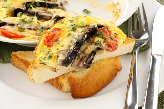 Delicious mushroom and tomato bake served on toast for breakfast.