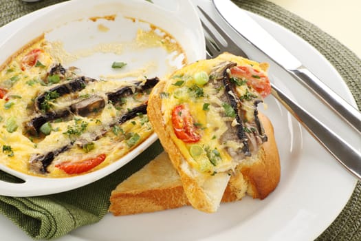 Delicious mushroom and tomato bake served on toast for breakfast.