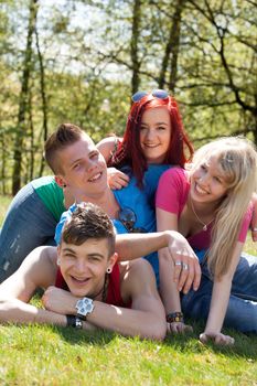 Young teenage group with colored shirts are having fun 