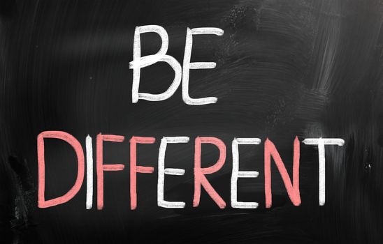 Be different handwritten with chalk on a blackboard