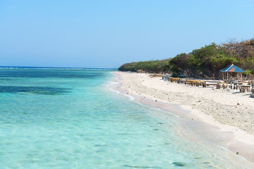 Beautiful beach with blue clean water and seaside cafe on tropical beach. Selective focus on front water.