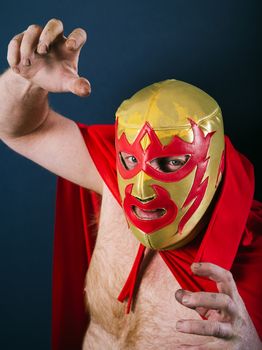 Photograph of a Mexican wrestler or Luchador standing in a fight pose.