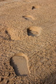 Trail of foot steps on the beach