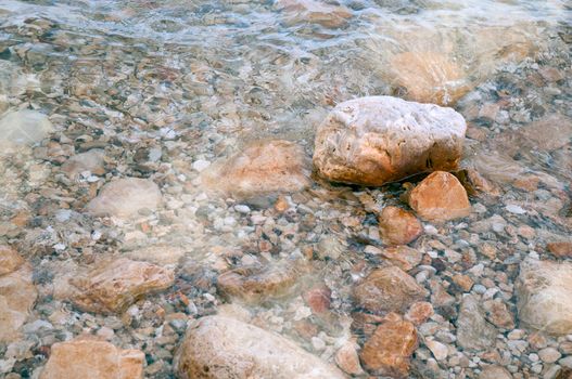 Untouched nature abstract archipelago in seashore with rocks in water on Dead sea . Israel