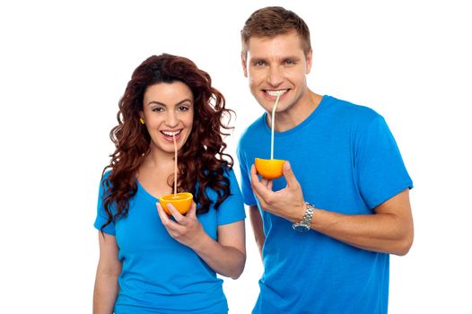 Drink healthy, stay healthy. Attractive couple drinking fresh orange juice