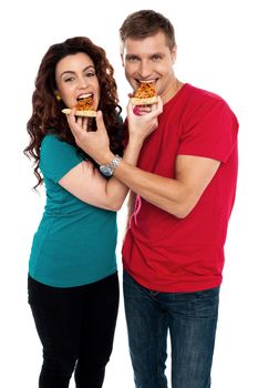 Adorable love couple enjoying pizza pie together. Both making each other enjoy pizza piece