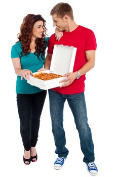 Love couple sharing pizza. Enjoying together. Full length shots