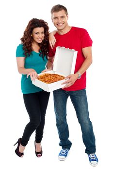 Young couple about to enjoy pizza together. Woman resting hand on her boyfriends shoulder