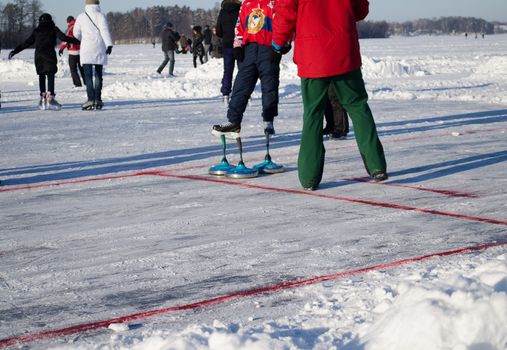people play winter game curling eisstock and slide skating kit frozen lake ice.
