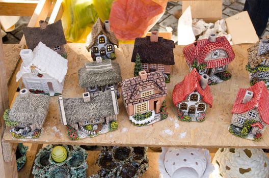 handmade craft decor clay houses sell in outdoor street fair market event.