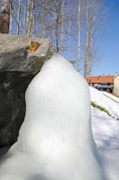 small park streem brook waterfall water frozen to big huge winter art icicle ice piece.