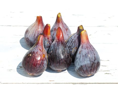 Fresh fig fruits on white wooden background, closeup