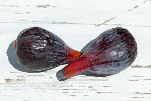 Fresh fig fruits on white wooden background, closeup