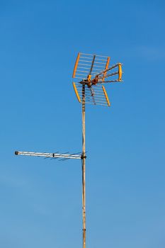 Television aerial against a blue sky, closeup 