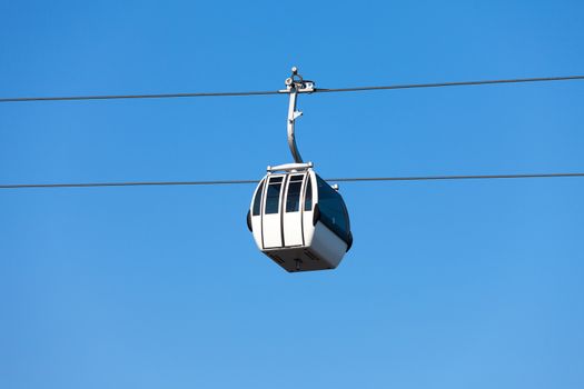 Cable car on blue sky background, in Expo district, Lisbon, Portugal