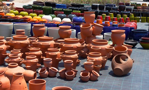 Colorful ceramic pots in market, sunny day