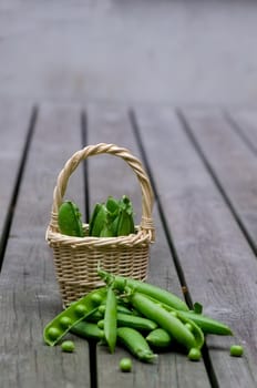 Fresh peas on a background of old boards