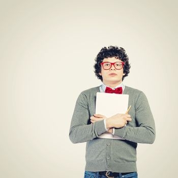 Young man in glasses standing and holding papers