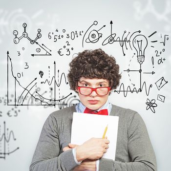 Young man in glasses standing and holding papers against background with different symbols