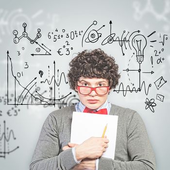 Young man in glasses standing and holding papers against background with different symbols