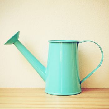 Blue retro watering can with filter effect