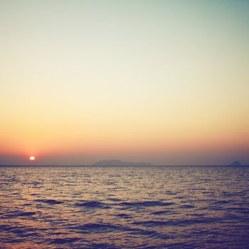 Sunrise over the sea with retro filter effect