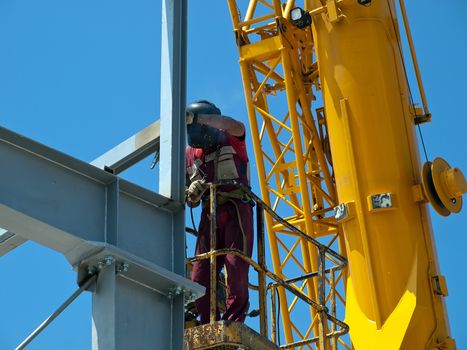 welder with protective mask welding metal construction