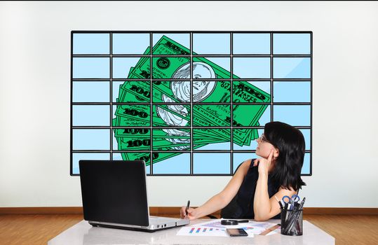 businesswoman in office looking at dollars on plasma panel