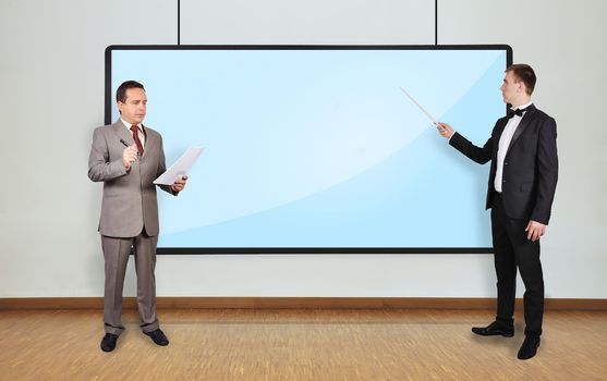 two businessman in office and plasma blank panel on wall
