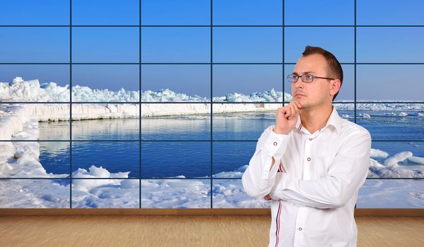 businessman thinking in office and ice ocean  on plasma panel