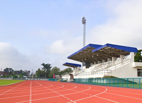 Stadium main stand and running track with blue sky background