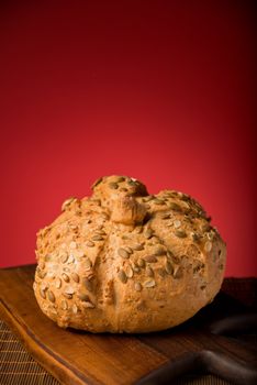 Crusty bun on a wooden board isolated in studio