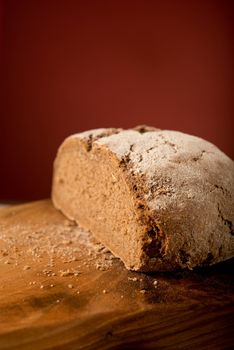 Wholegrain bun cut in studio isolated on dark red