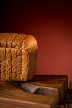 Bread slices and a board isolated on dark red