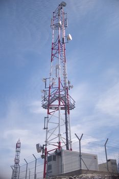 Radiotelecommmunications tower with antennas on a blue sky