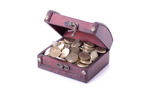 concept of saving pound coins in a treasure chest.