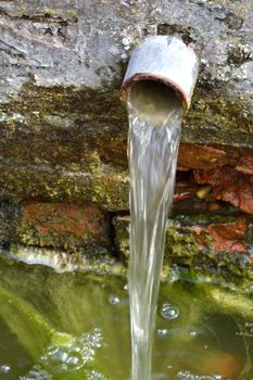 Small pipe of water in garden