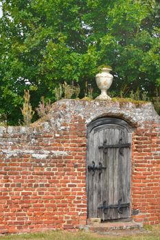 Garden gate with red brick wall