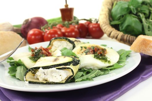 Zucchini rolls and stuffed mozzarella on a light background