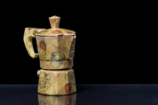 A decorated Moka italian coffee machine with fruit and vintage handcrafted decoupage work on a reflective black surface with black background







A decorated Moka italian coffee machine with fruit and vintage handcrafted decoupage work