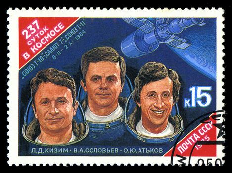 USSR - CIRCA 1985: stamp printed in USSR, shows portraits Cosmonauts L. Kizim, V. Soloviov, O. Atkov and Spacecraft Salyut-7, circa 1985